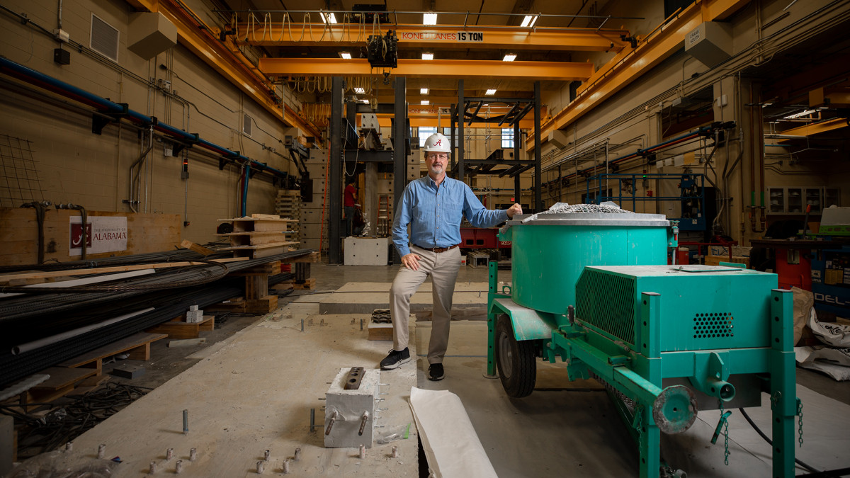 Professor in hard hat in a large structures lab