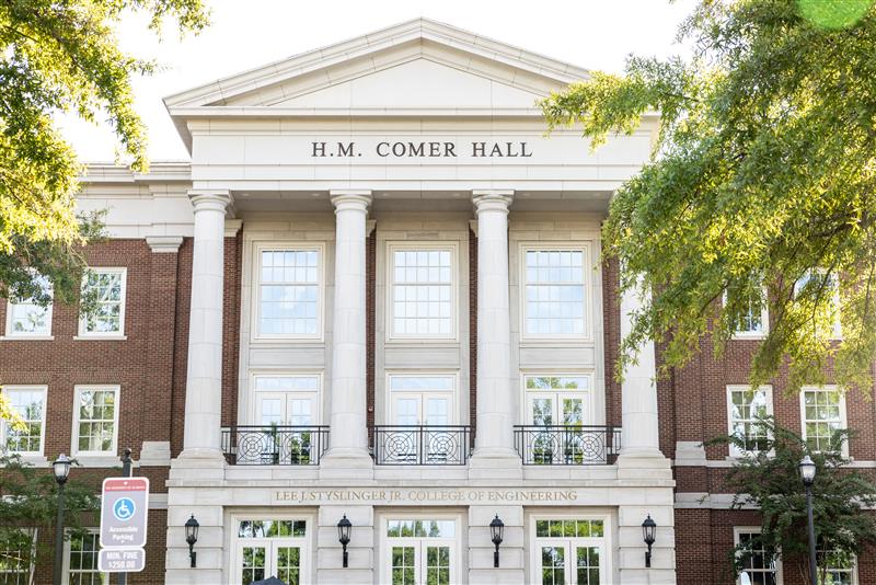 4 men pose in a beige room