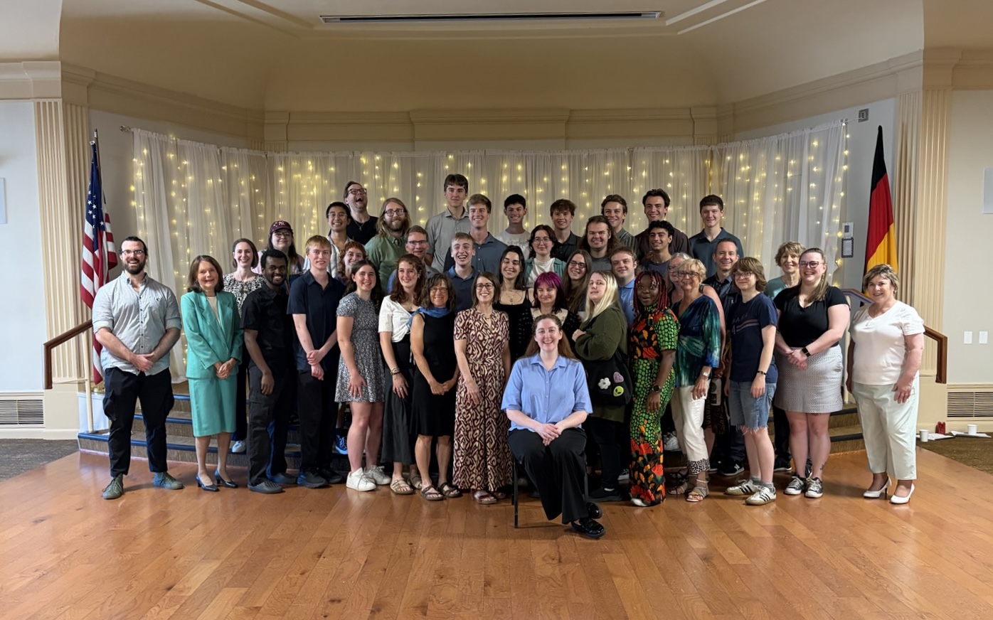 massive group picture in a large room with wood panneled flooring